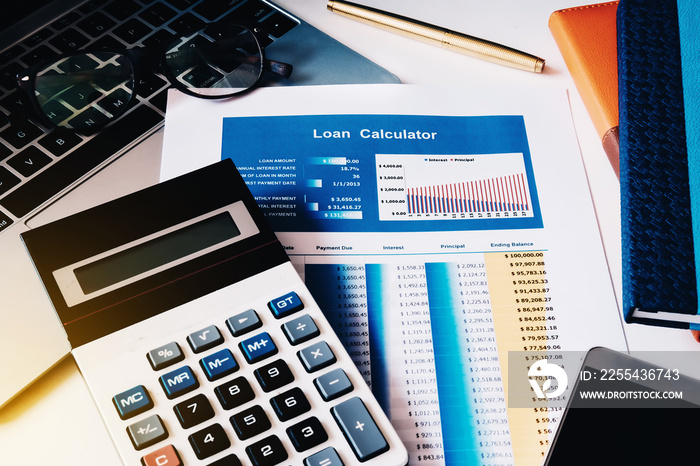 Loan concept, Loan Calculator paper with calculator, computer labtop, notebook and smart phone on the table.