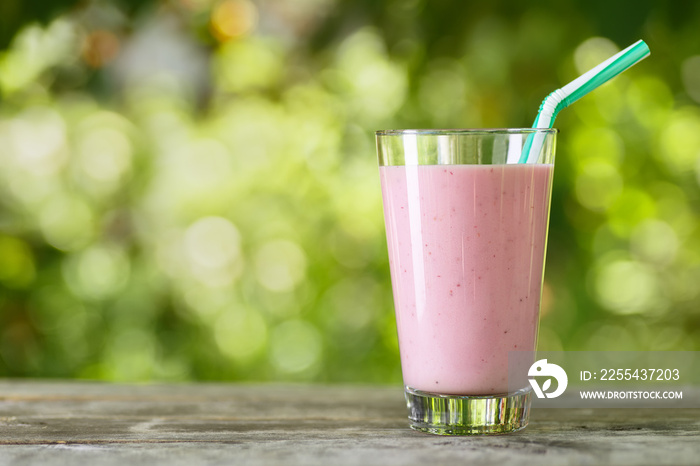 pink milkshake in glass on table