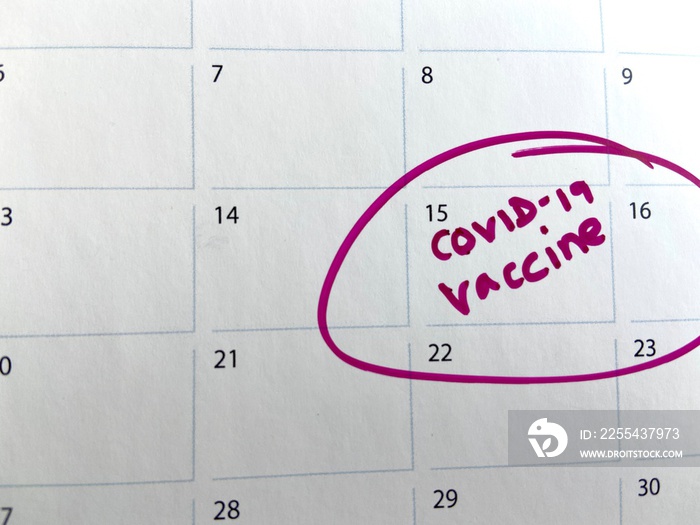 covid-19 coronavirus vaccine vaccination shot appointment reminder on calendar,  background with copy space, covid 19 or covid-19 booster vaccine shot being rolled out out across uk