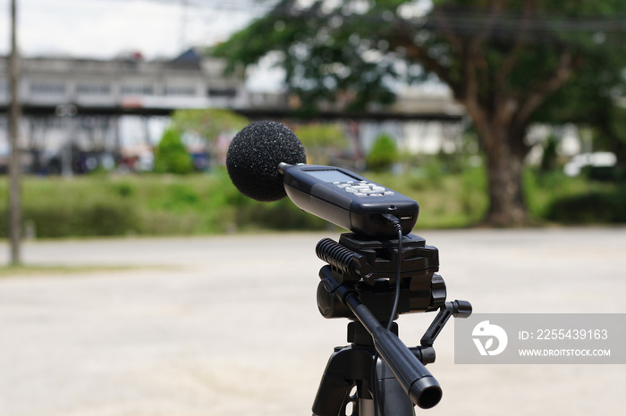 Measuring the noise on the road with a sound level meter.