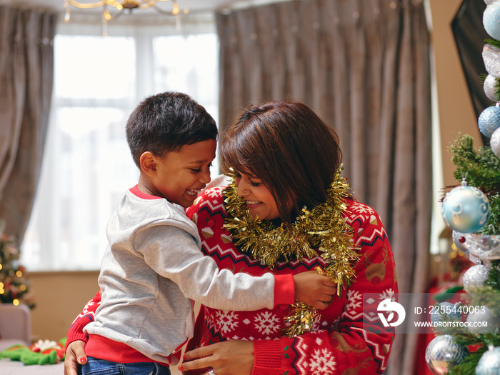 Mother and son playing with Christmas decorations