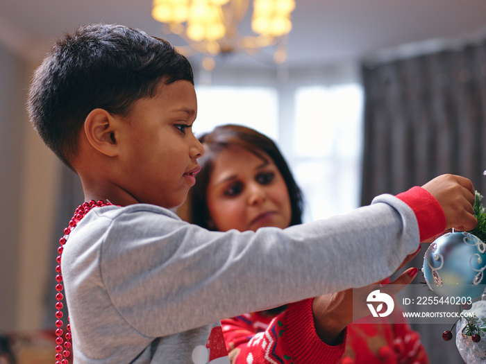 Mother and son decorating Christmas tree