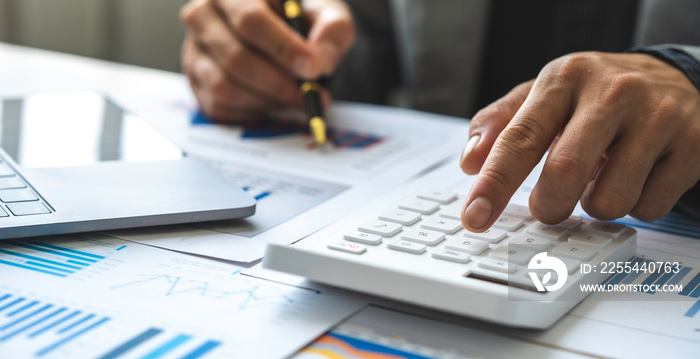 Business accounting concept, Business man using calculator with computer laptop, budget and loan paper in office.