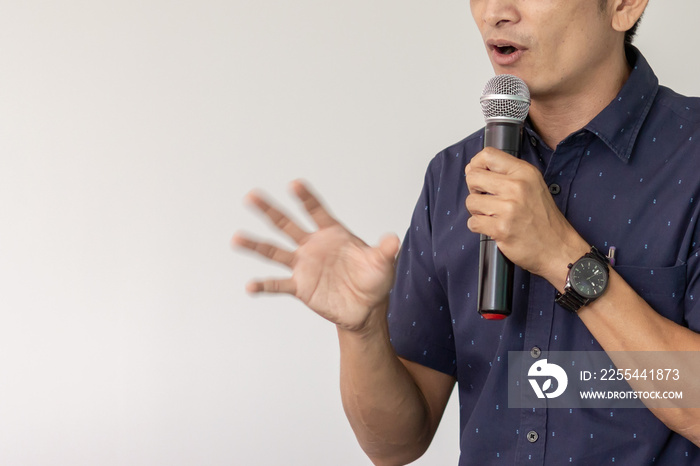 Man holding microphone for lecturing technical articles.