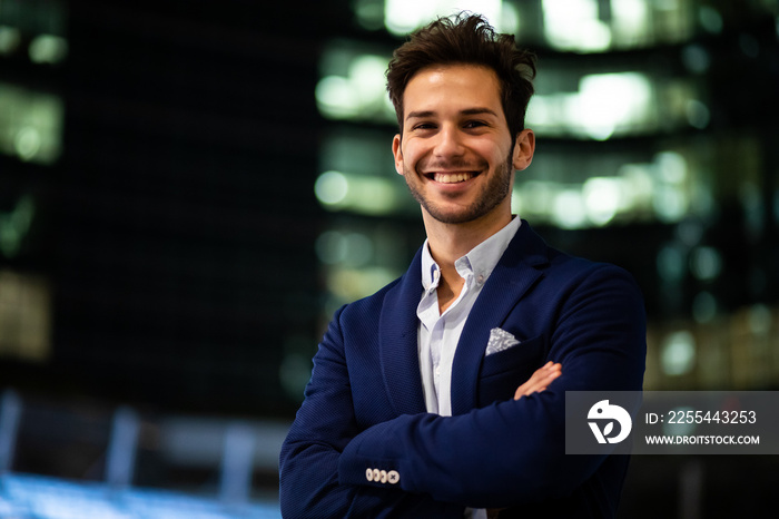 Young businessman outdoor in a modern city setting at night