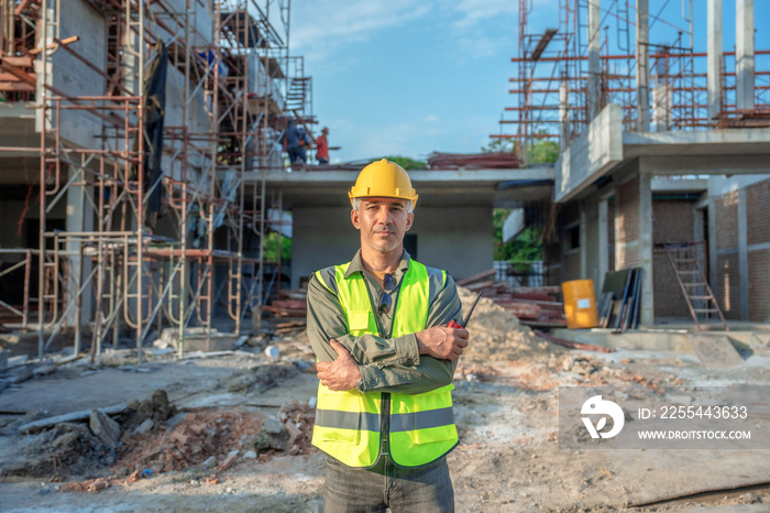 Portrait of Caucasian male worker in front of construction site.