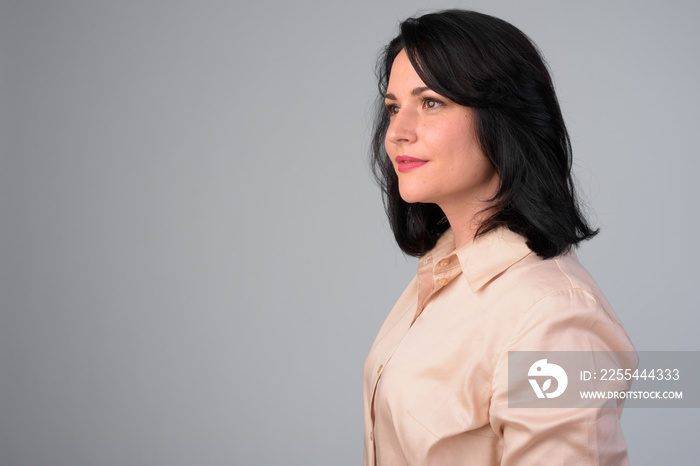 Profile view of beautiful businesswoman against white background