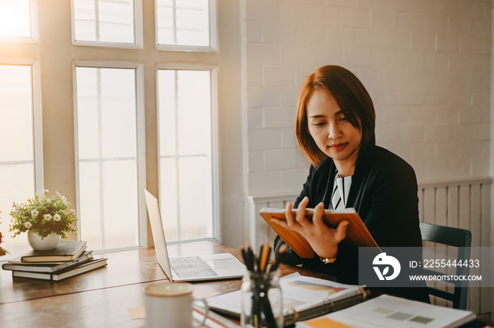 Businesswomen checklist on board and working on office desk.