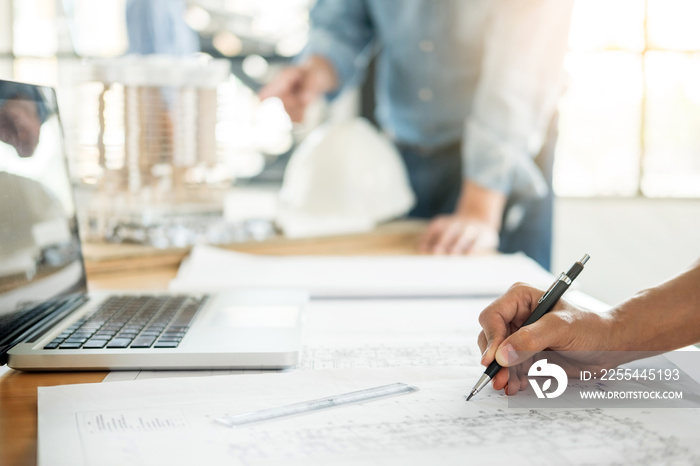 Close-up Of Person’s engineer Hand Drawing Plan On Blue Print with architect equipment, Architects discussing at the table, team work and work flow construction concept