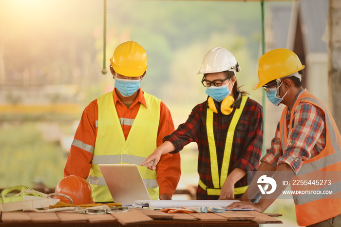 Corona or Covid-19 wear masks during the design of construction. New normal.Industrial engineering team wears a COVID 19 protective mask. Workers wear a quarantine face mask.