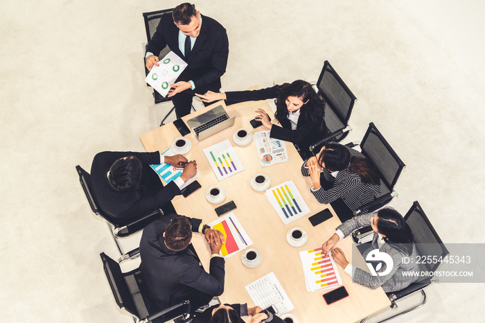 Business people group meeting shot from top view in office . Profession businesswomen, businessmen and office workers working in team conference with project planning document on meeting table .