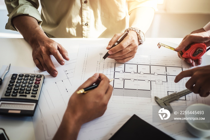 engineer people meeting working and pointing at a drawings in office for discussing. Engineering tools and construction concept.