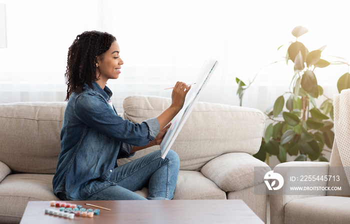 Quarantine Leisure. Young Black Woman Drawing Painting On Canvas At Home