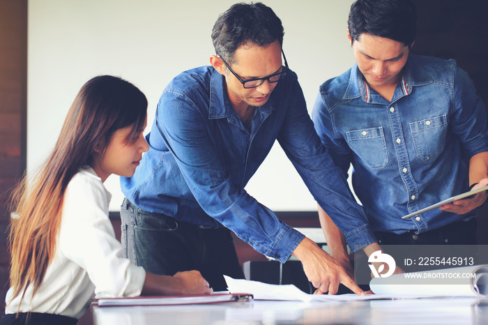 group of engineer/architect/worker man and woman discussing about building plan for construction