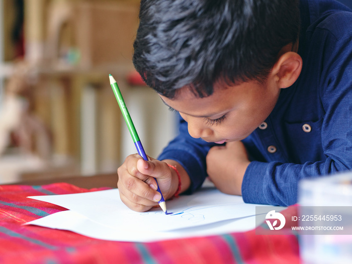 Boy drawing on paper