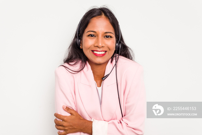 Telemarketer Indian woman working with a headset isolated on white background laughing and having fun.