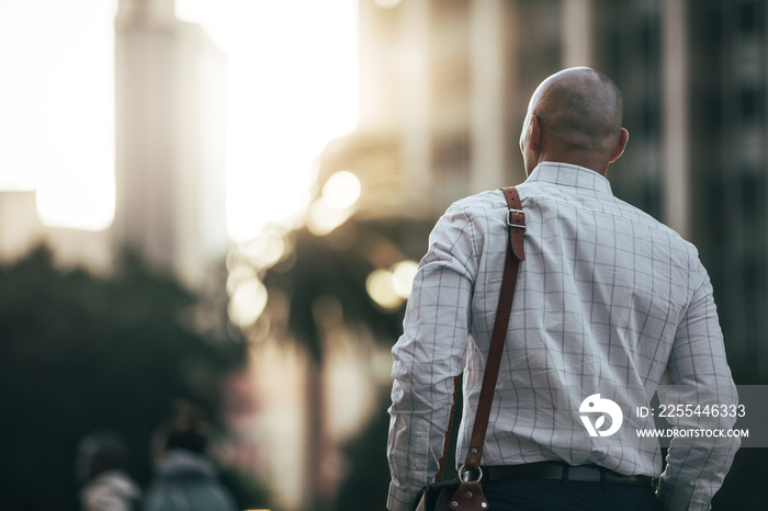 Businessman walking on street to office