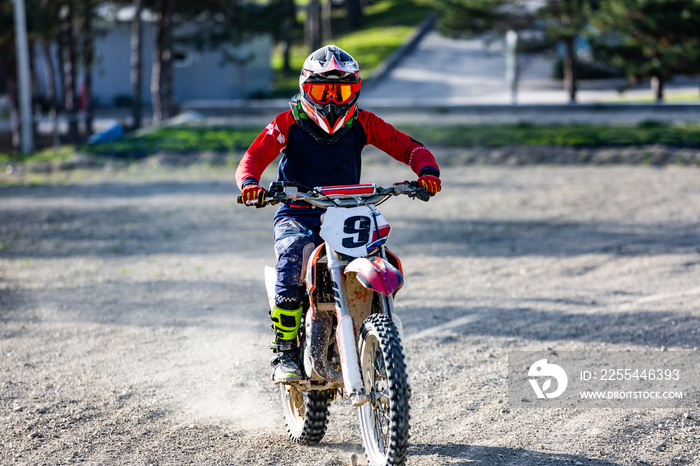 Professional Motocross Motorcycle Rider Drives Over the Road Track.