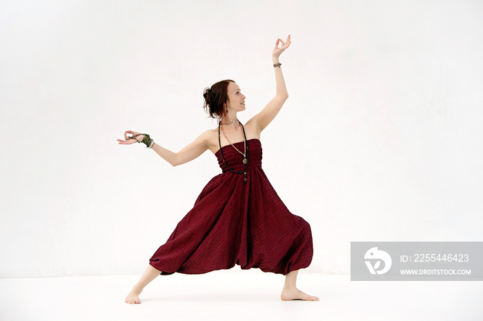 Dancing yoga woman. Photographed on a white background.