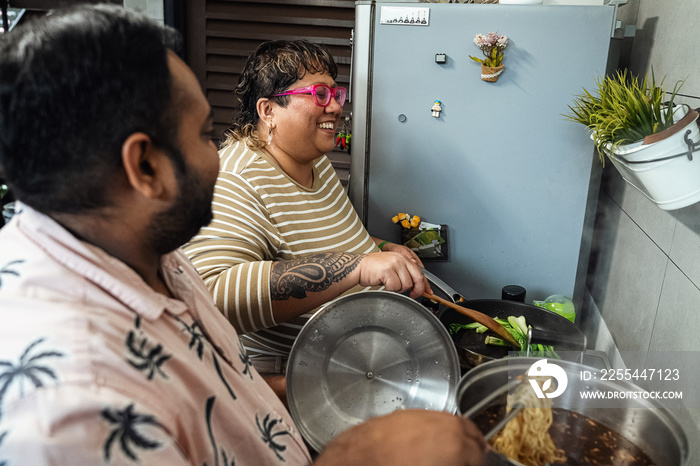 Plus sized parents making a healthy meal for the family