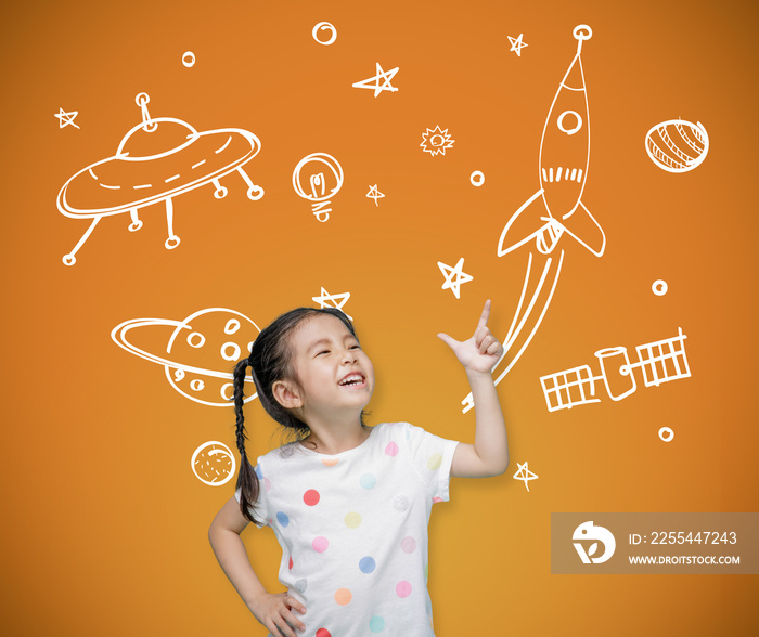 Asian child girl pointing at the blackboard with imagination the astronaut and space rocket, Creative and dreams of childhood concept