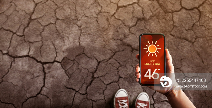 Water Crisis Concept. Environmental Impact. Global Issues in Agricultural. Standing on Cracked Soil with High Temperature Weather on Mobile Phone. Desertification, Pollution, Energy and Climate Change