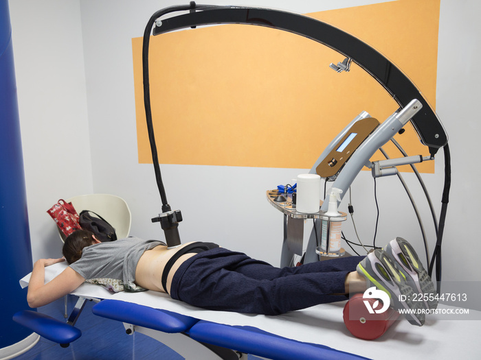 Diamagnetic Pump for Pain Therapy: Woman lying on aBed Undergoing Therapy