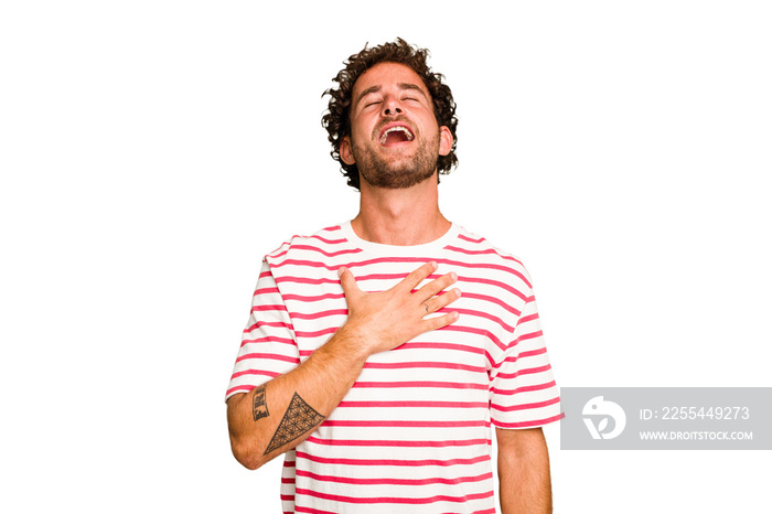 Young caucasian curly hair man isolated Young caucasian man with curly hair isolated laughs out loudly keeping hand on chest.