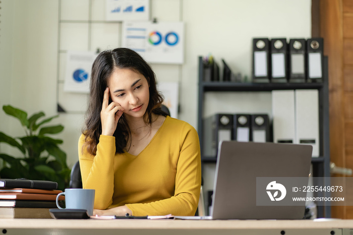 Asian businesswoman handling accounting tasks Accounting group meeting online and using laptop computer Professional confident employees in the office