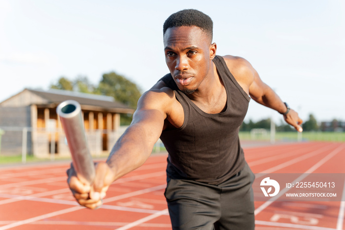 Athlete holding relay baton during race