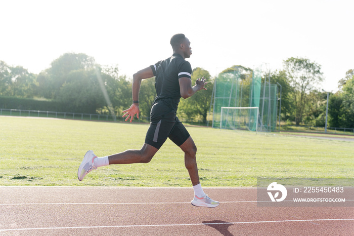 Athlete sprinting at running track