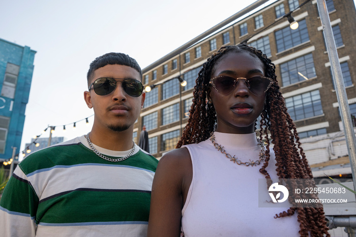 Fashionable young people wearing sunglasses,looking at camera