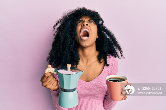 African american woman with afro hair drinking italian coffee angry and mad screaming frustrated and furious, shouting with anger looking up.