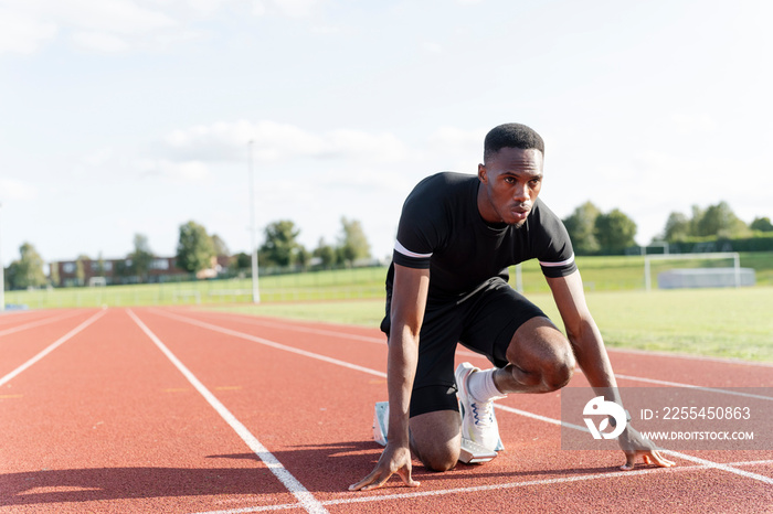 Athlete preparing to sprint at running track