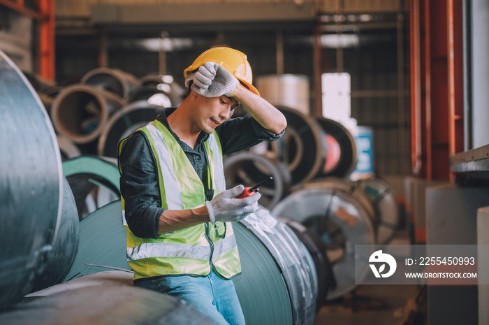 Asian man engineer  working hard in factory , worker employee  hard hat safety control machine factory