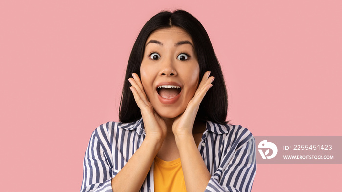 Close up portrait of shocked young asian woman screaming