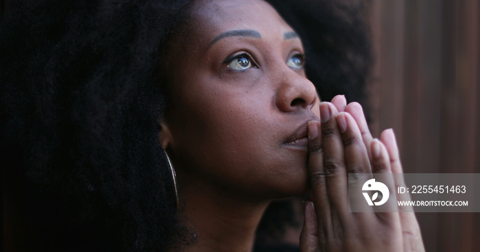 Hopeful African woman praying to God seeking FAITH and HOPE