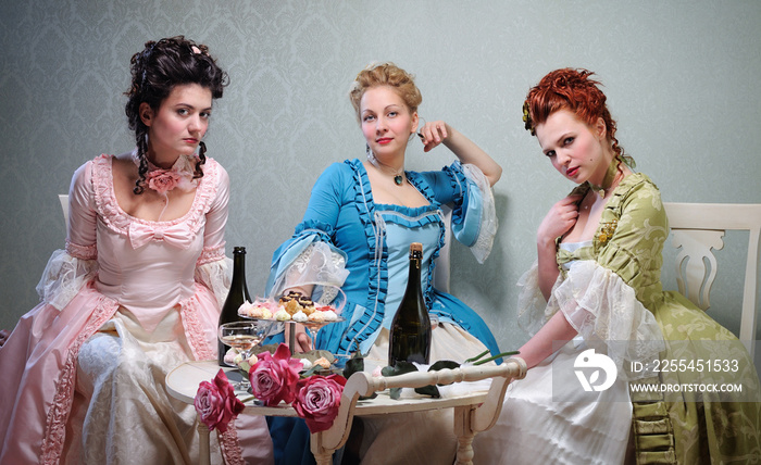 Three beautiful ladies in lavish dresses at a party in a historical setting