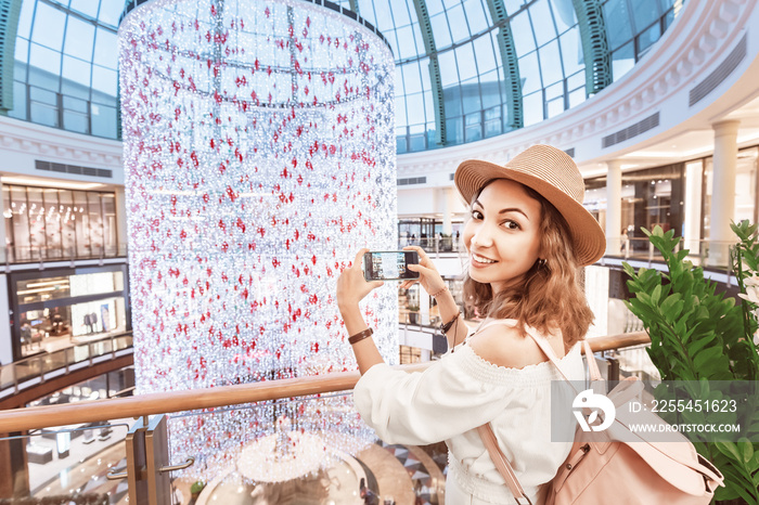 A young tourist walks through one of the largest shopping centers in Dubai - Emirates Mall