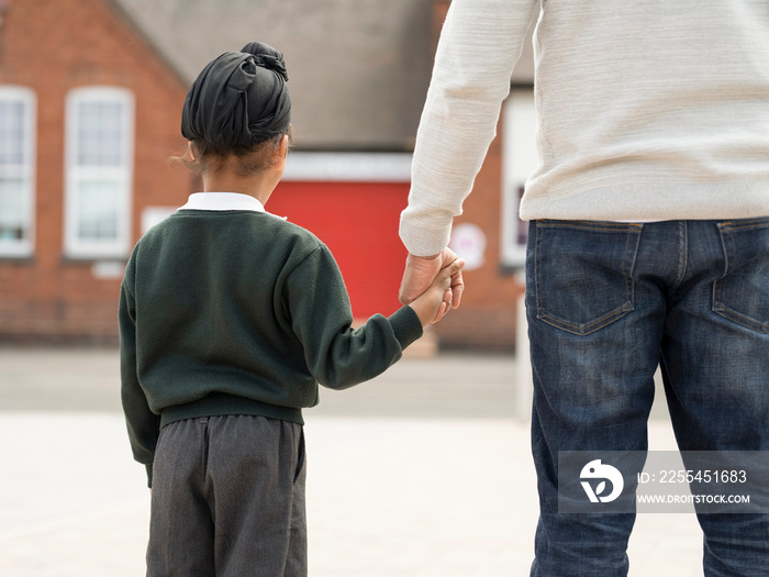 Father walking son (6-7) to school