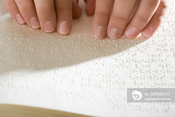 One woman reading braille