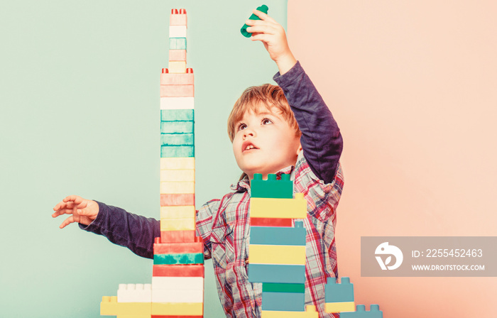 Little boy playing with lots of colorful plastic blocks constructor. Boy playing with construction blocks at kindergarten