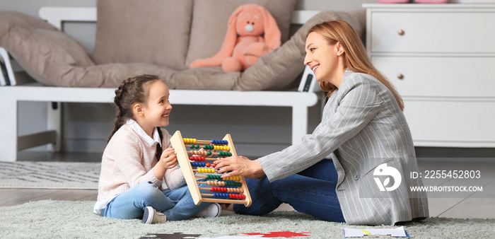 Female psychologist working with girl suffering from autistic disorder in office