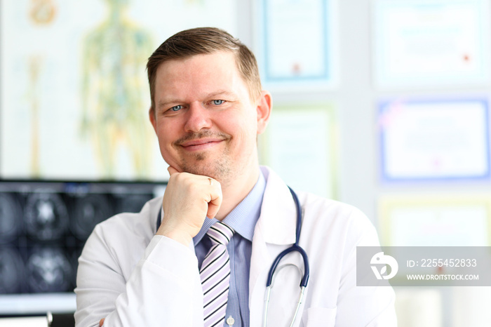 Adult smiling gp looking in camera in office portrait