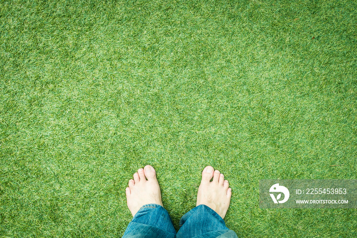 Bare feet with jean on grass floor vintage tone with copy space