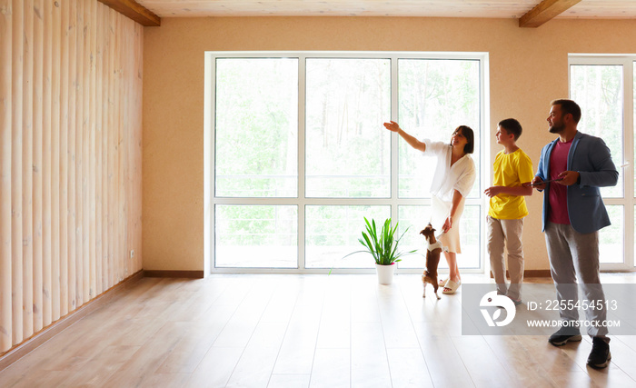 the family moves into a new apartment, inspects a new house, apartment, discusses the future interior. dad mom and son in a new empty apartment