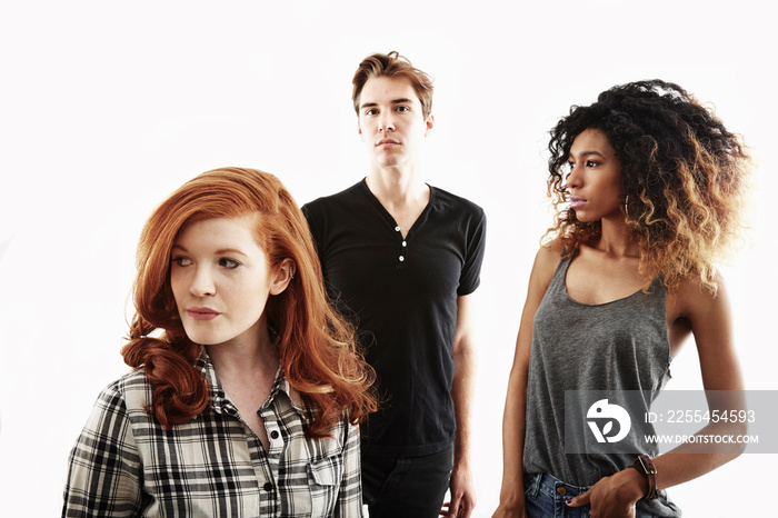 Studio portrait of  two young adult women and one young adult man