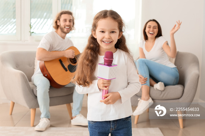 Cute little girl with microphone at home