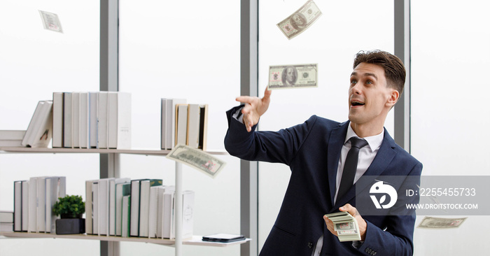 Happy Caucasian millionaire businessman entrepreneur owner in formal business suit gain profit standing enjoy throwing money banknote in office room. Rich man winner winning lottery or casino bets