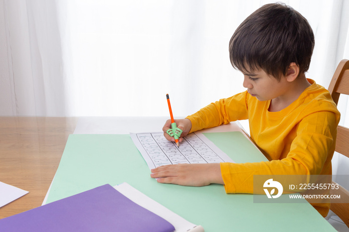 boy writing homework, handwriting correction tool, preschool writing training, children education at home